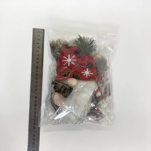 Christmas gnome plush with red knitted hat and white beard shown with measurement scale