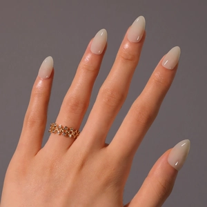 Elegant gold hollow star ring with tiny round gemstones worn on a finger