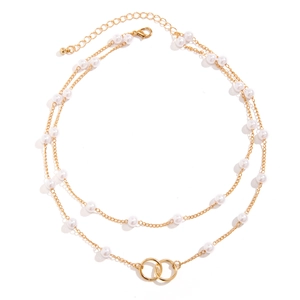 Detail of double-layer gold chain necklace with white pearls and interlocking rings