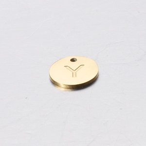 Detailed macro view of a 12mm golden stainless steel round charm featuring the letter Y