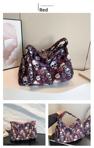 Detail of red nylon tote bag with skull and rose print showing texture and strap