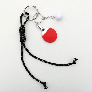 Detail of woven nylon cord with mini red table tennis paddle and ball keychain