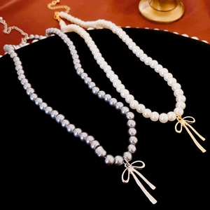 French vintage faux pearl bow choker necklace in white and grey on black velvet display