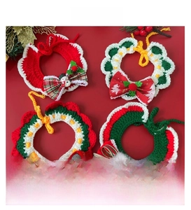 Detail of hand-knitted Christmas pet collars featuring elk balls and festive patterns
