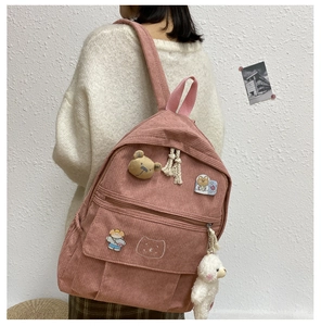 Mochila de pana rosa para niñas con lindos colgantes de peluche y correas ajustables