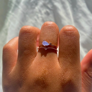 Creative rose gold rings set with blue teardrop gemstone and ocean style zircon detailing