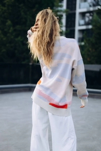 Outdoor back view of oversized knitted sweater with colorful abstract jacquard pattern