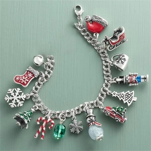 Detailed view of silver stainless steel charm bracelet with festive Christmas enamel icons