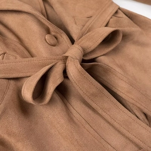 Close-up of the waist belt and fine texture of this brown faux suede biker jacket