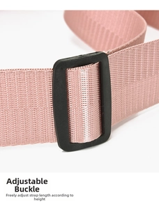 Macro detail of adjustable black buckle on pink woven strap for fashion crossbody bag