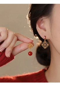 Detail of red zircon flower earrings featuring traditional Chinese gold hollow window designs