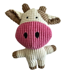 Plush squeaky dog toy in a cartoon cow design with textured corduroy fabric on white background