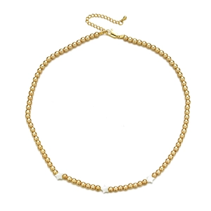 Detail of gold beaded necklace featuring three white shell star pendants and lobster clasp