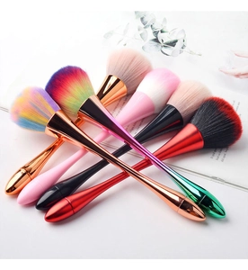 Artistic arrangement of diverse makeup brushes with metallic handles and colorful bristles
