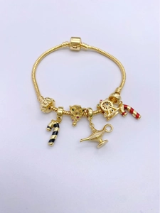 Detail of 18k gold-plated snake chain bracelet with festive Christmas charms