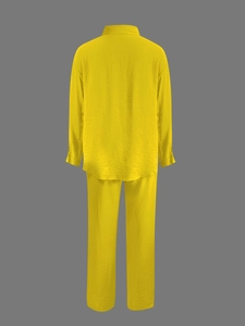 Rear view of yellow crepe fabric long sleeve shirt and trousers two-piece set