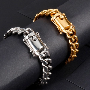 Close-up of thick gold and silver stainless steel Cuban chain bracelets on display