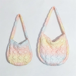 Detailed comparison of pink gradient quilted down bags in two different sizes on white