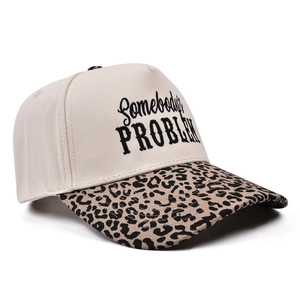Close-up of trucker hat with Somebody's Problem embroidery and leopard print brim