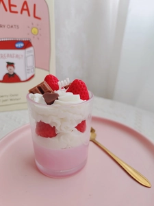 Detail of pink strawberry chocolate dessert candle in glass with soy wax topping