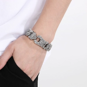 Close-up of vintage engraved silver chain bracelet for men with rock totem pattern