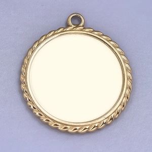 Macro shot of gold stainless steel round pendant with twisted rope edge for DIY jewelry
