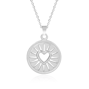 Macro shot of silver heart pendant with sunburst detail and rope border on O-chain