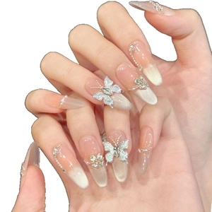 Long almond cat-eye press-on nails with 3D silver butterfly and pearl chain ornaments