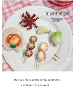 Set of creative food-shaped hairpins including octopus and scallops on white plate