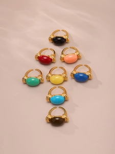 Colorful resin gemstone rings in gold-plated open bands displayed in pyramid arrangement