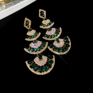 Detail of four-tier fan-shaped earrings with emerald drop and white zircon pavé