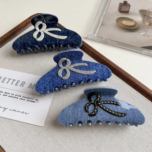 Three denim texture shark hair claws with rhinestone bows in dark, mid, and light blue