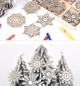 Close-up of wooden snowflake ornaments with twine hangers on a frosted pine tree