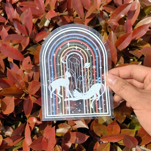 Holographic arch suncatcher sticker featuring cats and crystals on a rainbow backdrop
