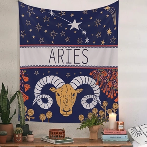 Detail of Aries zodiac tapestry with gold ram design and floral accents on blue fabric