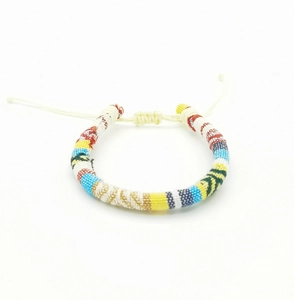 Close-up of colorful Bohemian hand-woven bracelet with adjustable knot on white background