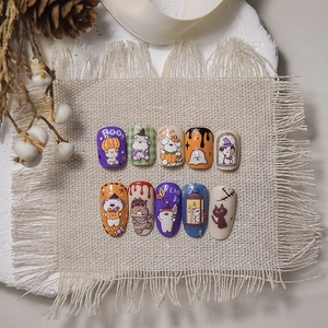 Halloween hand-painted style press-on nails with pumpkin, ghost, and cat motifs