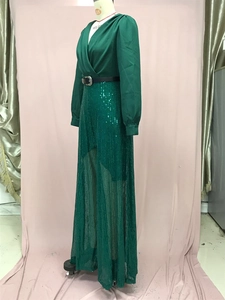 Detail of dark green V-neck jumpsuit with sequined mesh overlay and metallic belt