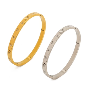 Detail view of gold and silver stainless steel heart bangles with crystal accents