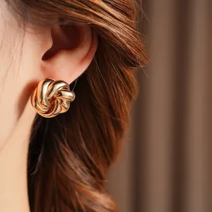 Elegant gold twisted knot earrings for women in a minimalist metallic floral swirl design