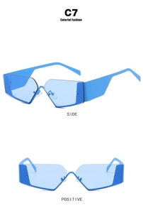 Futuristic rimless Y2K sunglasses in bright blue with irregular geometric cut-out design