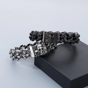Gothic punk skull bracelets in silver and matte black steel on geometric blocks