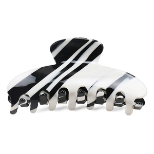 Macro shot of large acetate hair claw clip featuring black and white swirled pattern