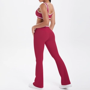 Detail of burgundy yoga set featuring contrast piping on sports bra and flared pants