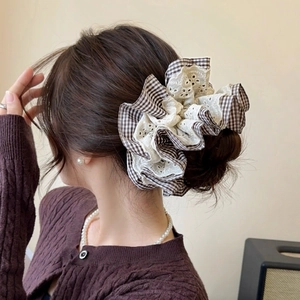 Brown houndstooth scrunchie with beige lace trim for elegant hairstyling and accessorizing