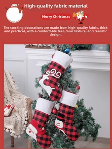 Close-up of buffalo plaid Christmas stockings with 3D reindeer, snowman, and Santa motifs