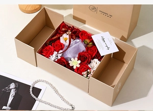 Close-up of heart gift box with soap roses, LOVE ribbon and purple jewelry mesh pouch