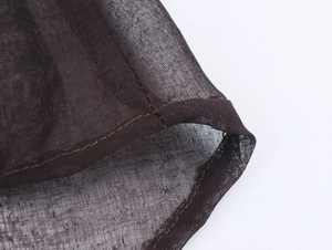 Detailed macro shot of dark brown mesh fabric texture with fine stitching craftsmanship