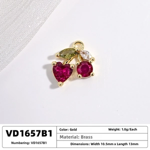 Macro shot of cherry pendant with dimensions 10.5mm x 13mm in gold brass and red gems