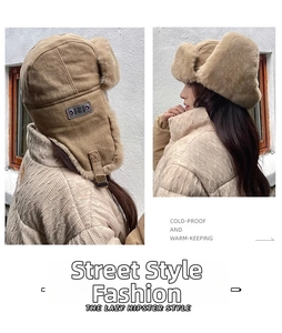 Detail of warm winter trapper hat with camel suede shell and soft faux fur lining